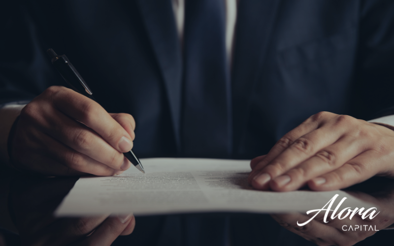 corporate finance: Foto macro de caneta assinando contrato em papel sobre mesa de escritório
